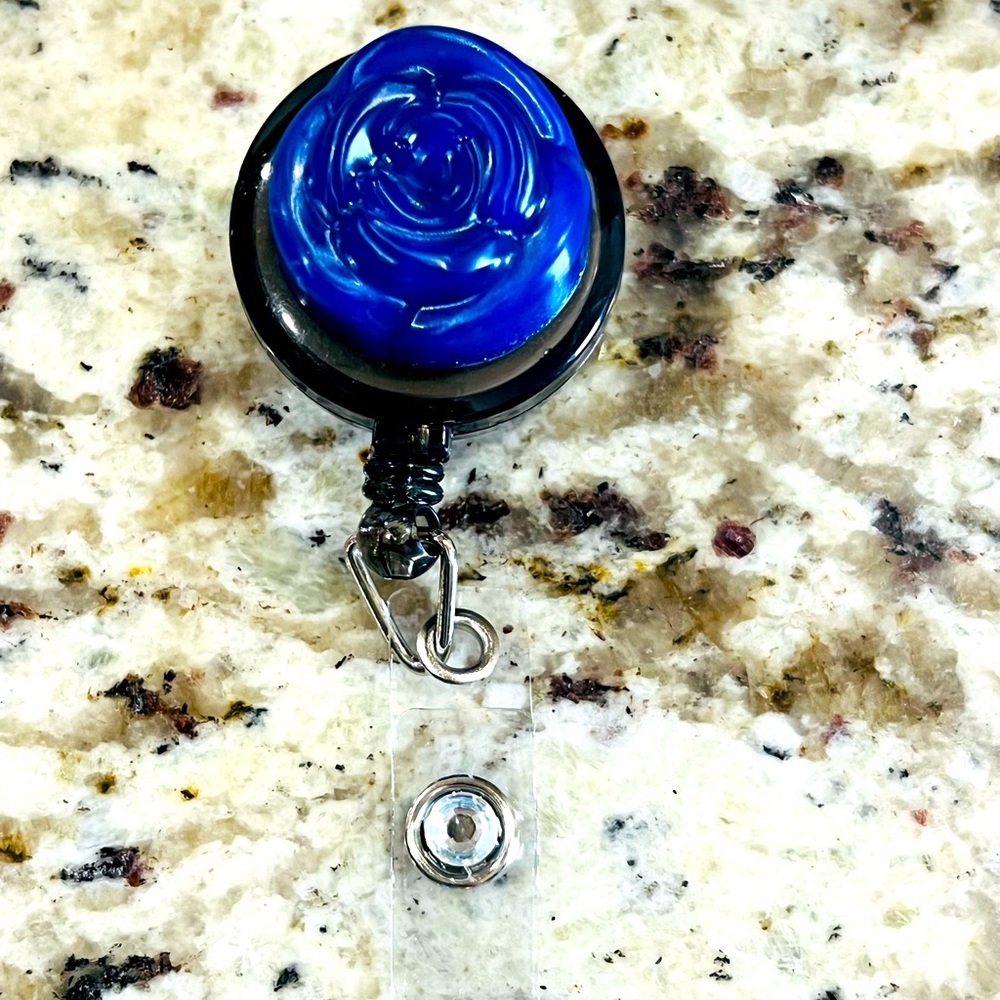 Blue flower and diamond badge reel.